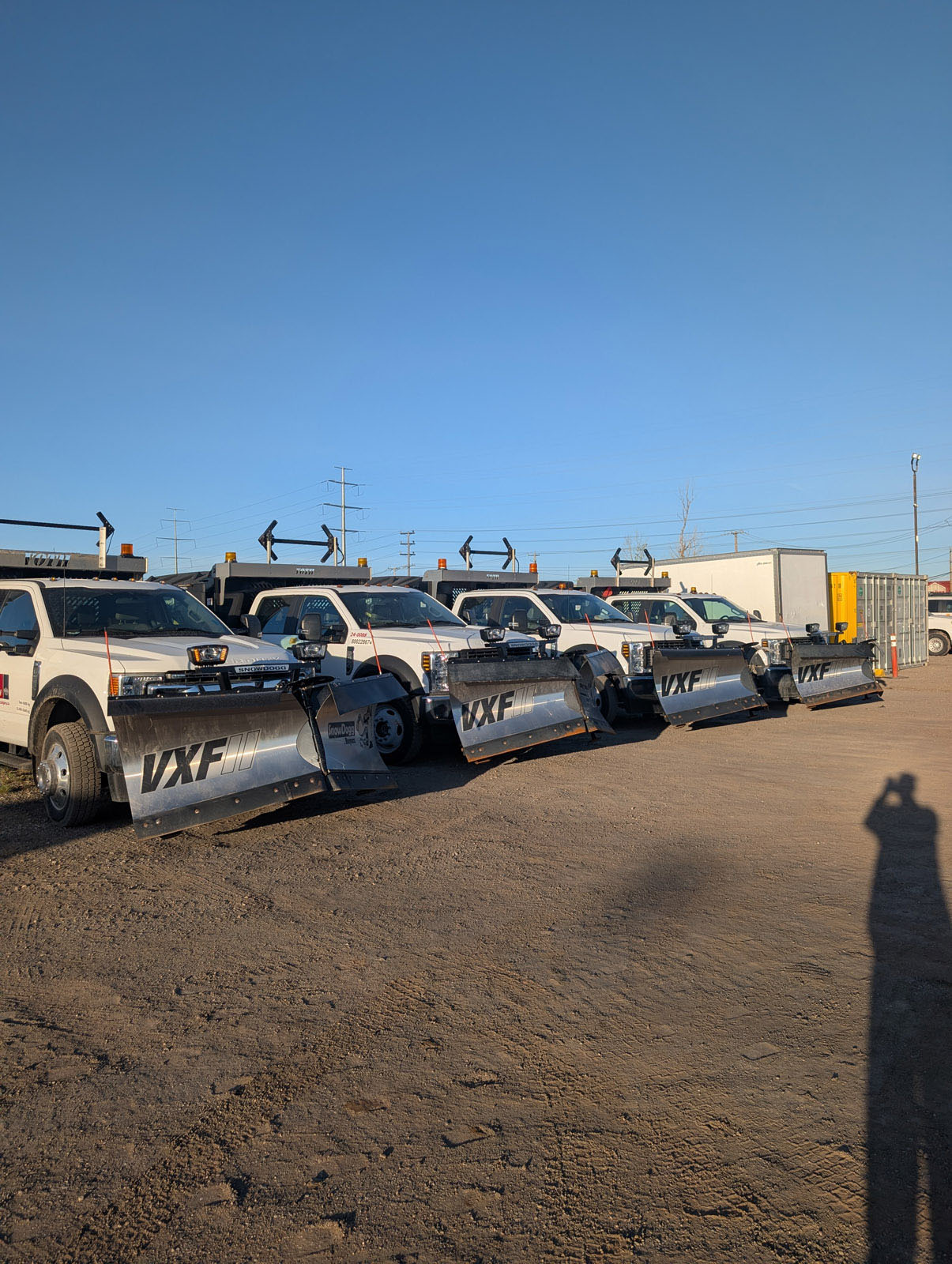 Commercial snowplow trucks lined up for fleet transportation work.